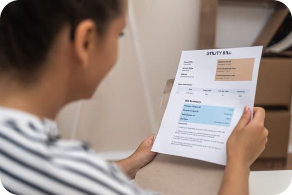 woman looking at her utility bill
